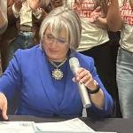 MLG holds photo op at ABQ school to sign two anti-gun bills