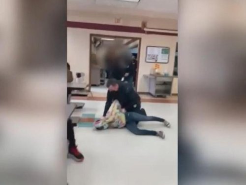 An off-duty officer put his knee on a 12-year-old girl's neck to break up a school fight. The girl is now being charged