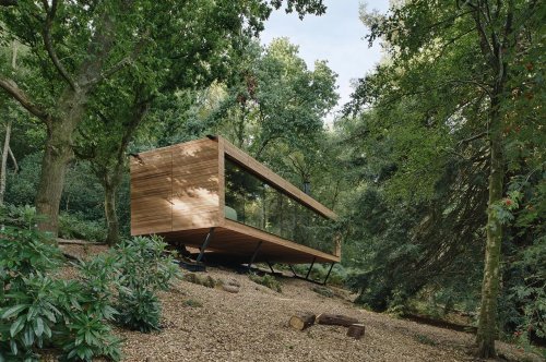The Looking Glass Lodge is a picturesque woodland retreat with glass facades that let you connect with nature