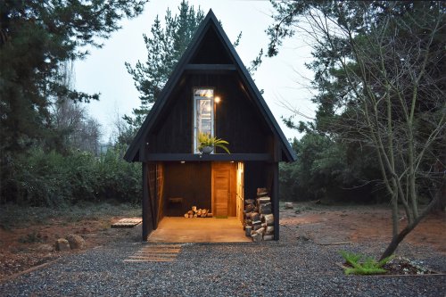 This elevated prefab cabin has a buffer zone that helps protect it against harsh climate!