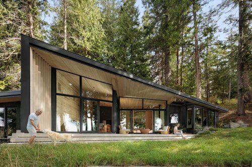 Angular black cabin in the woods of British Colombia is the peaceful haven nature lovers dream about