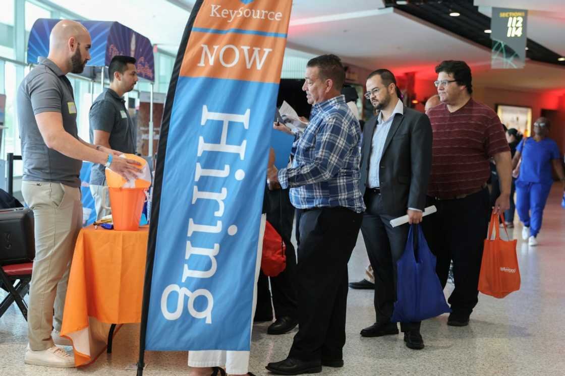 US hiring slows less than expected, unemployment unchanged