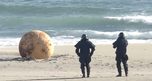 Authorities alarmed as giant sphere washes up on Japanese beach